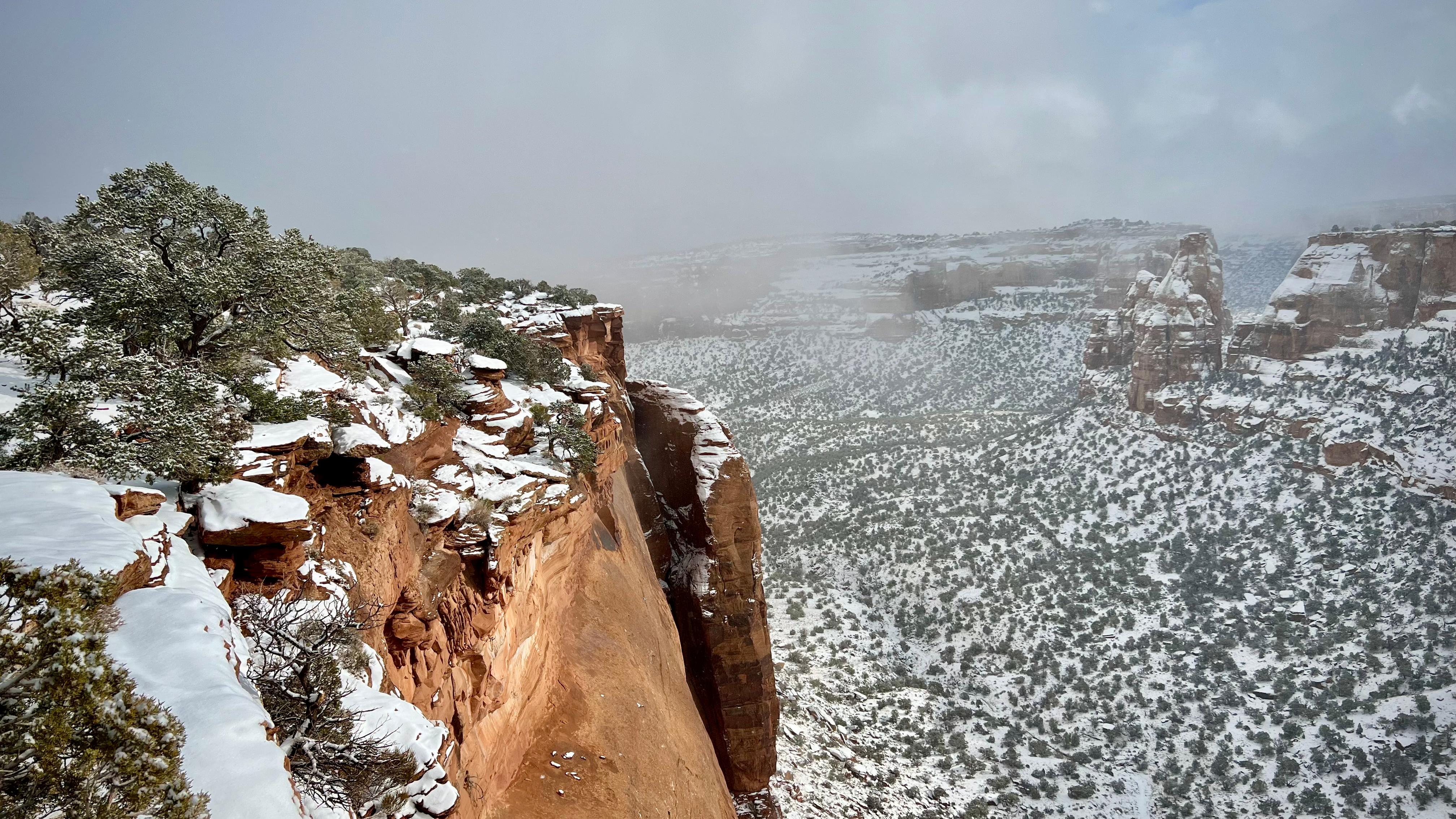 red sandstone cliff topped in fluffy white snow