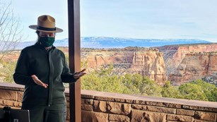 Ranger connects virtually with students with a view of canyons in the background.