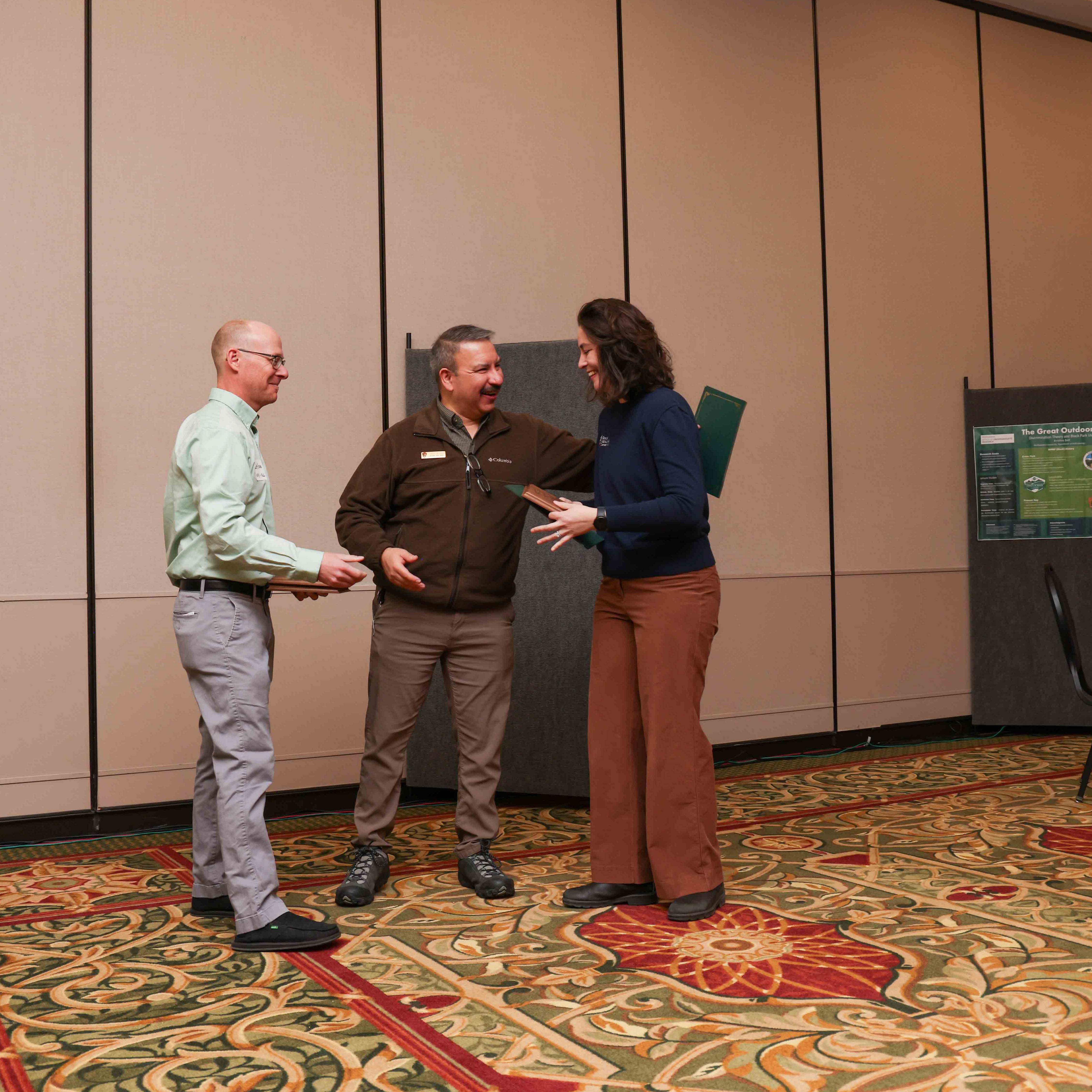 Park staff present an award to a park partner.