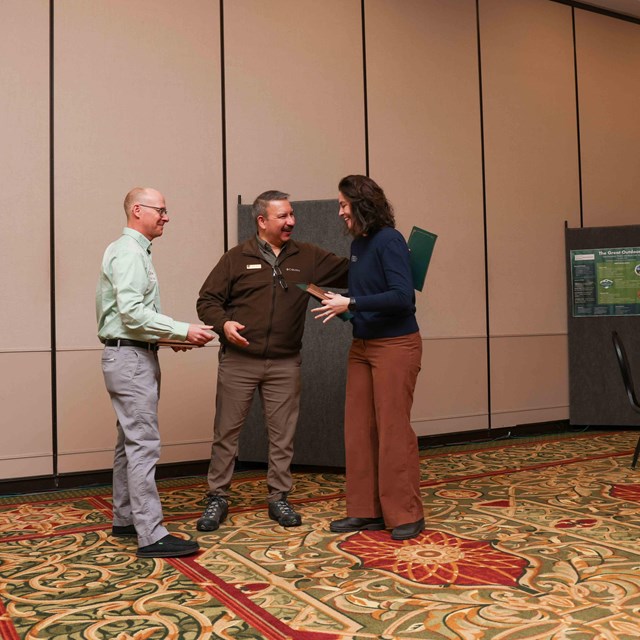 Park staff present an award to a park partner.