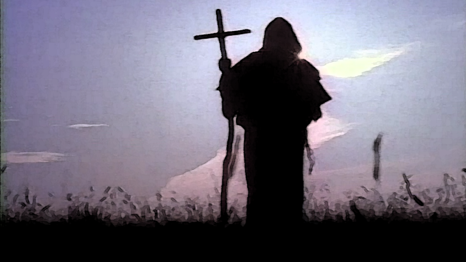 Silhouette of a person wearing a priest's robe standing in a field of tall grasses, holding a cross.