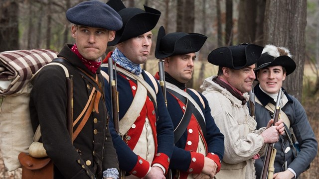 Picture of several reenactors standing in a row. 