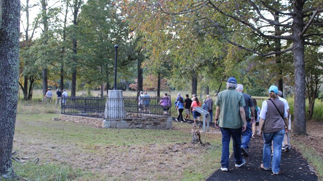 Visitors walk past the Washington Light Infantry Monument. 