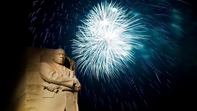 Fireworks go off in a display behind the Martin Luther King, Jr. Memorial at night