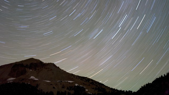 star trails form circular patterns in dark night sky