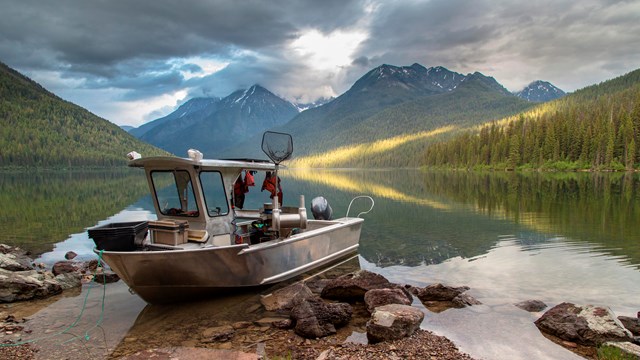 Boat near a lake surrounded by mountains