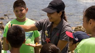 Youth volunteer talking to a group of kids