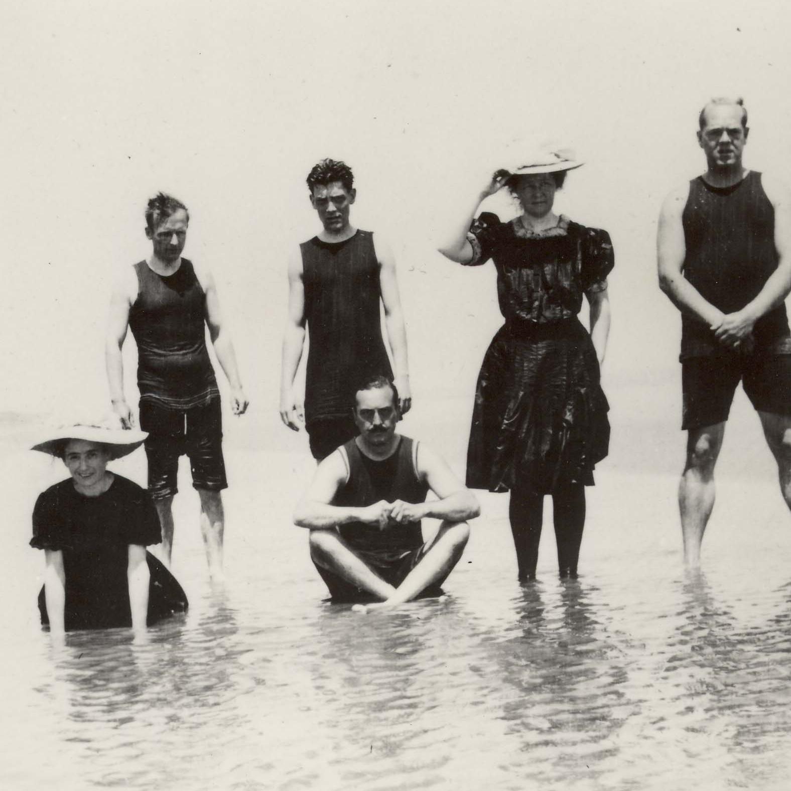 Historical photo of people in swimming costumes in water 