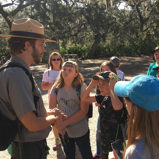 A park ranger talks to a group of kids