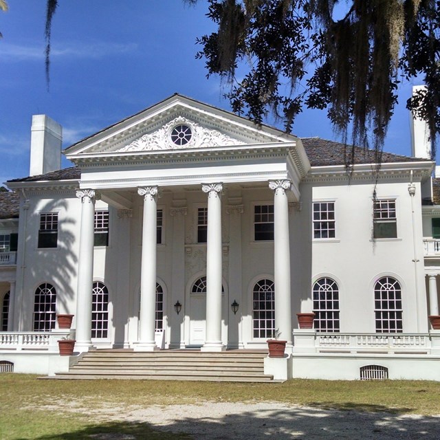 Large white mansion under blue skies