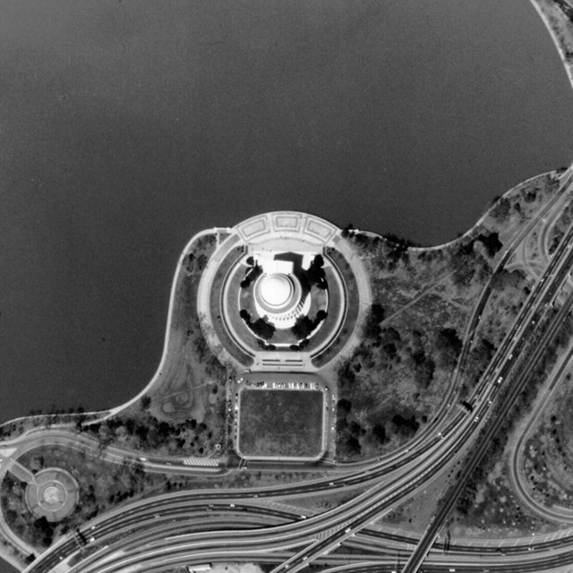 Aerial view of round Thomas Jefferson Memorial and landscape at the edge of the Tidal Basin.