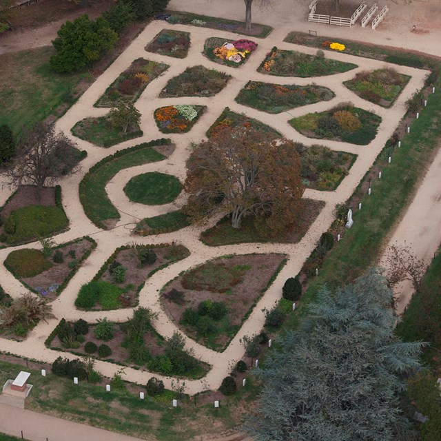 Aerial view of the symmetrical walkways and planting beds of the formal garden. 