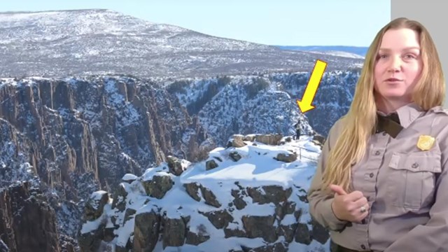 Park ranger wearing a grey shirt stands in front of a screen showing a canyon with snow