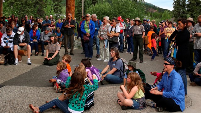 A woman shows art to a group of people