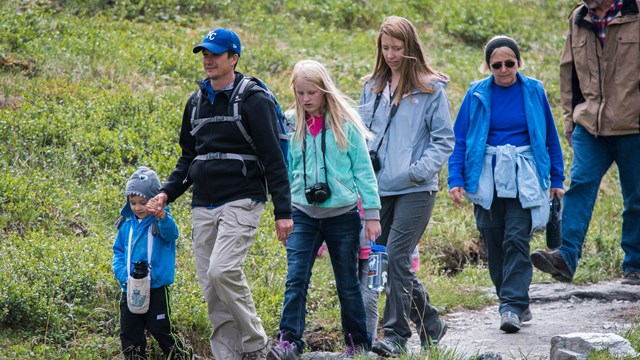 Children and adults hiking on a trail