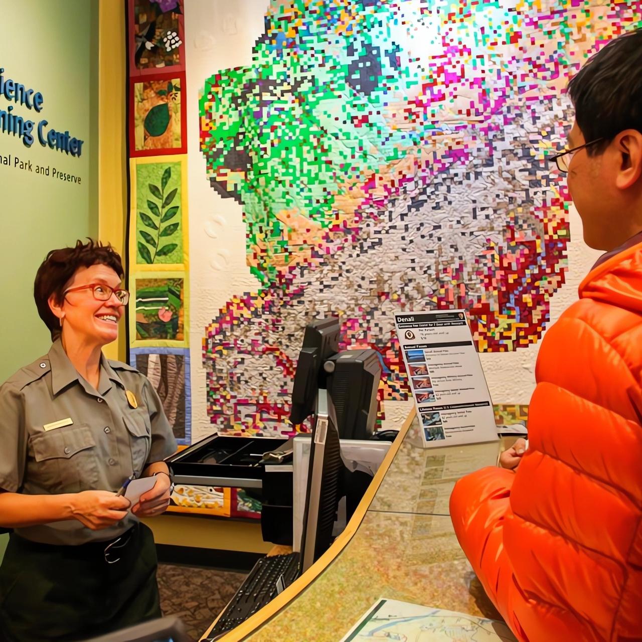 A park ranger greeting winter visitors at the Murie Science & Learning Center
