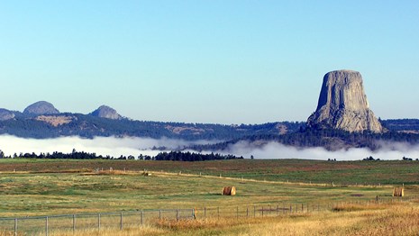 Devils Tower and the Little Missouri Buttes rise above the fog.