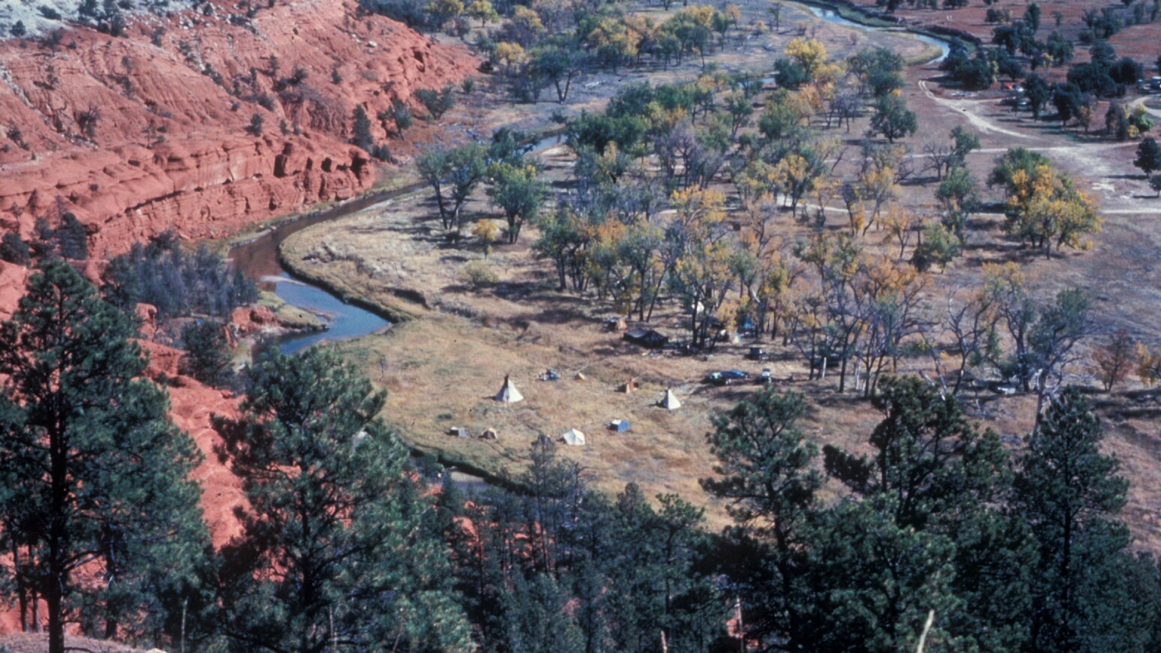 Tepees alongside the Belle Fourche river, viewed from above