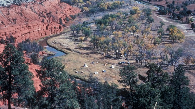 Tepees alongside the Belle Fourche river, viewed from above