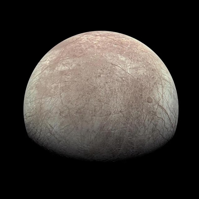  The image showcases a celestial body's upper hemisphere against a pitch-black background. 