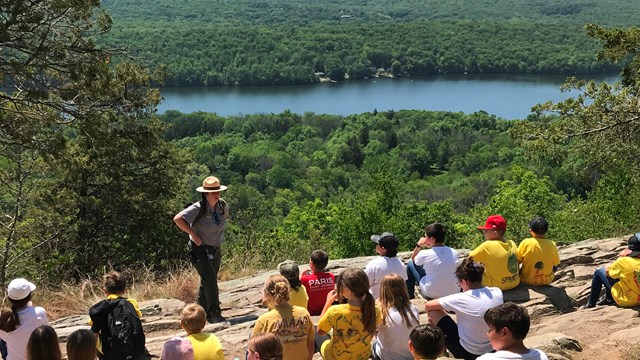 A ranger talking to a bunch of students at a viewpoint on the Appalachian Trail.