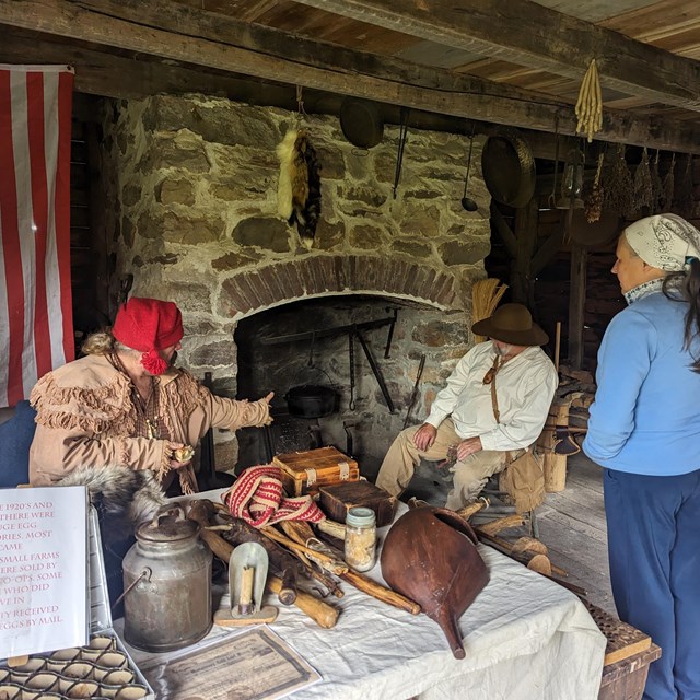 A Millbrook Village Society volunteer practicing 19th century cooking techniques.