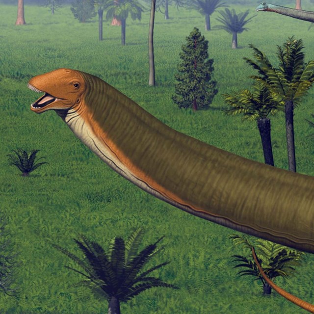A huge, long-necked dinosaur with a green body and orange face.