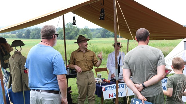 A living history volunteer speaks to visitors