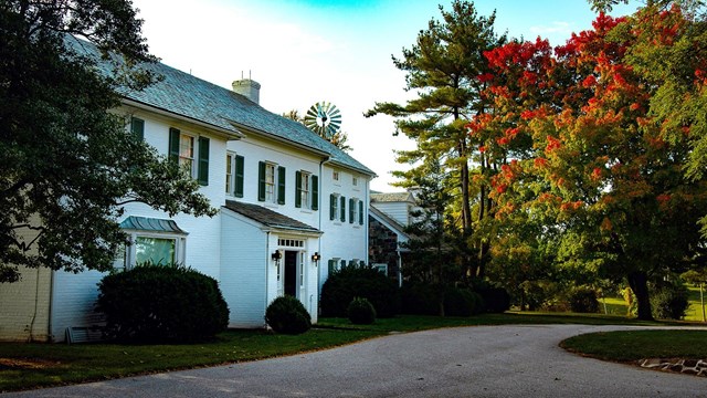 A color image of the Eisenhower home surrounded by fall foliage