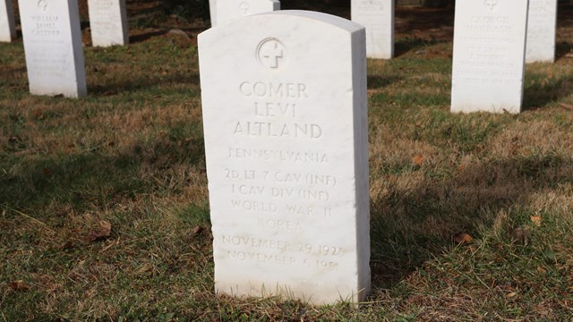 A white granite headstone for Comer Levi Altland