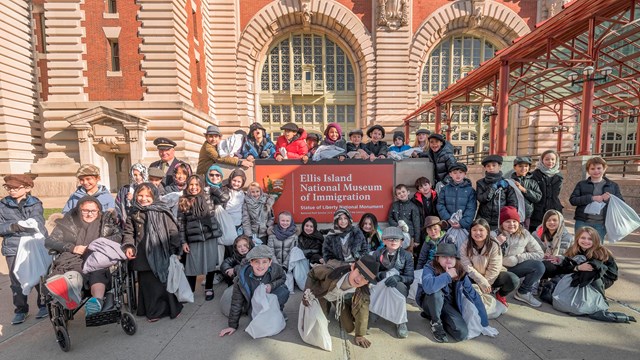 A class of school kids dressed as if they were immigrating through Ellis Island 100 years ago