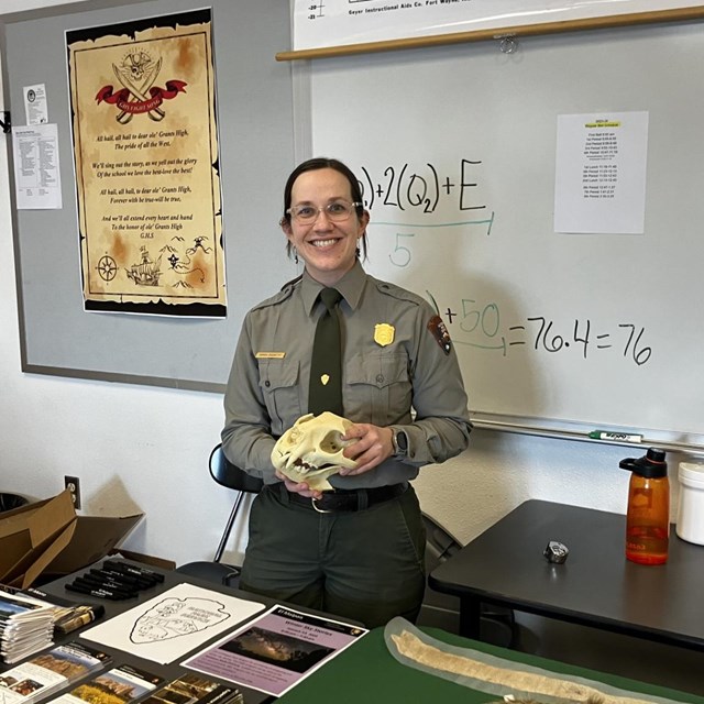 Female park ranger in classroom holding a skull