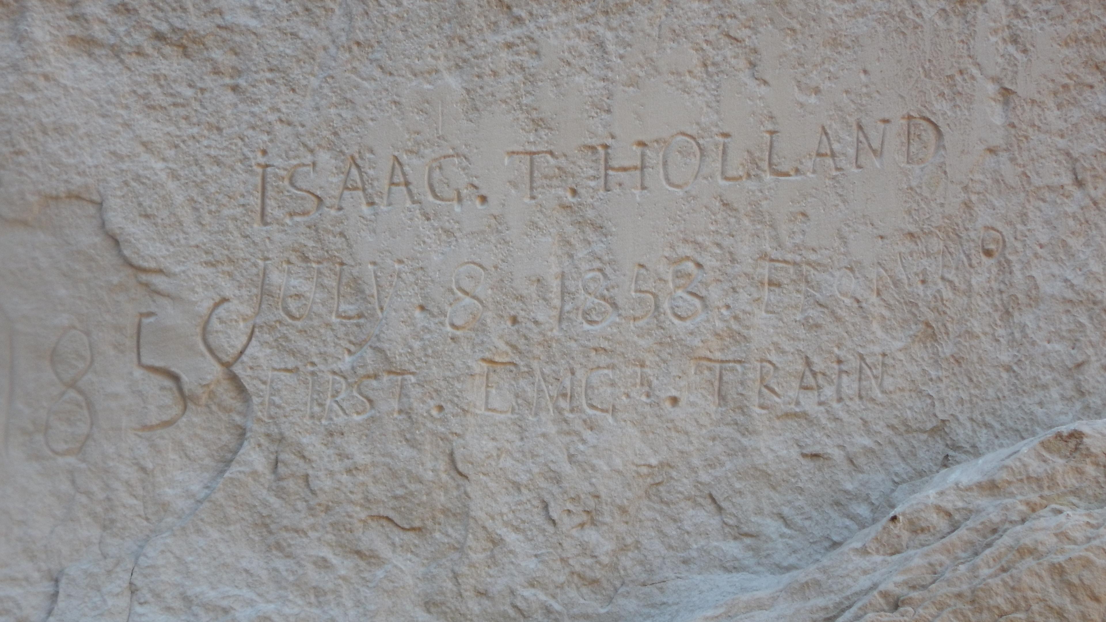An inscription reading "Isaac. T. Holland July 8, 1858 First Emg. Train"