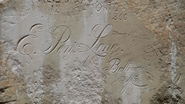 A calligraphy inscription on a rock.