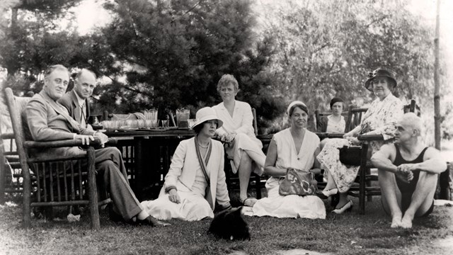 A group of people gathered together on a lawn.