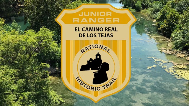 A shield badge with "junior range" set on an image of a clear creek running through a vegetated area