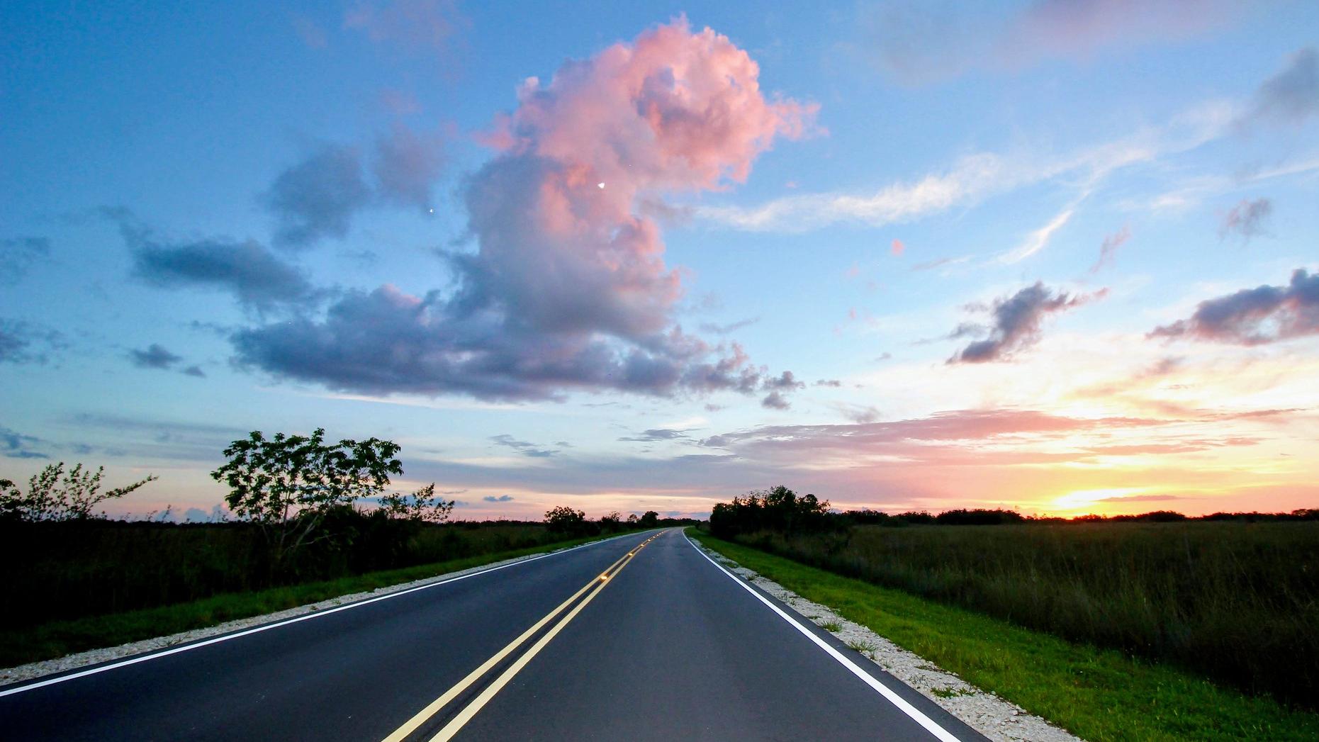 Road under a light blue and pink sky.