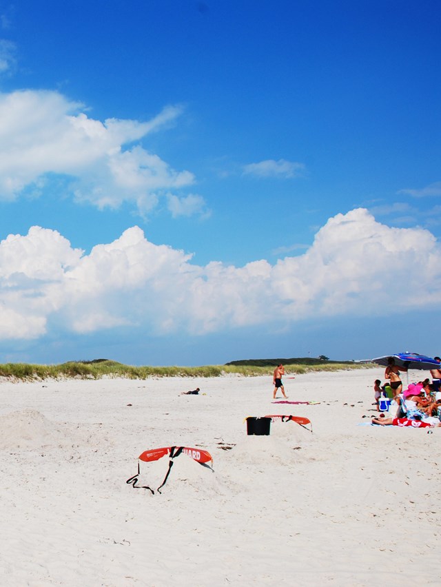 A lifeguard watches over a calm summer beach.