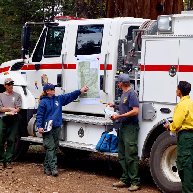 A fire captain gives a morning briefing to fire crews.