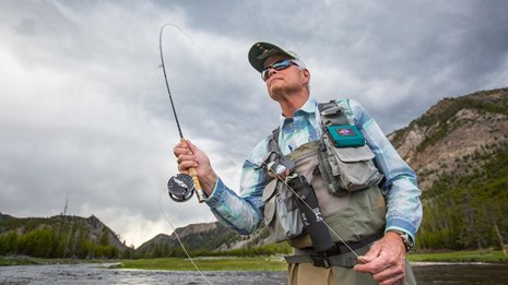 a man with a fly fishing pole