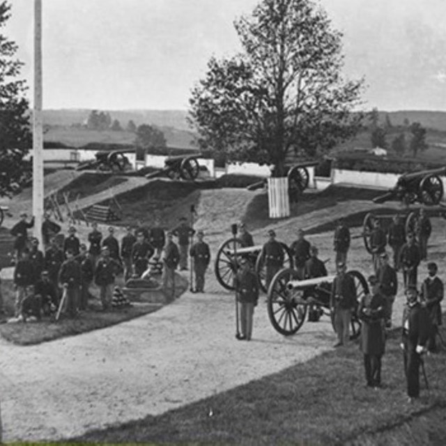 A black and white image in front of green space