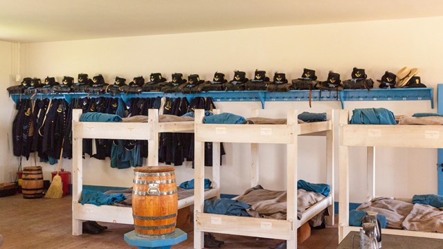Army bunk beds in historically restored barracks building.