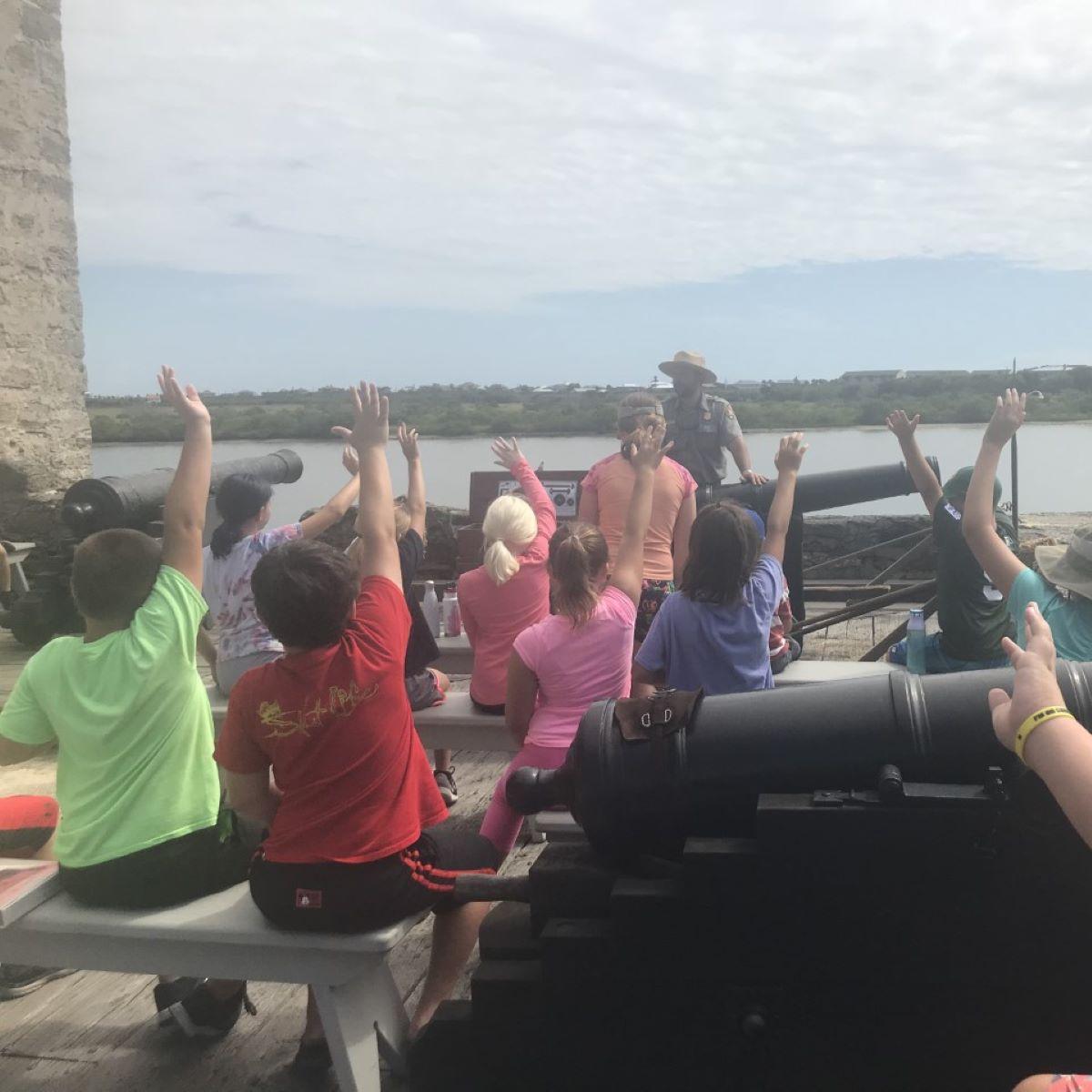 Group of students with a ranger on the gun deck. 