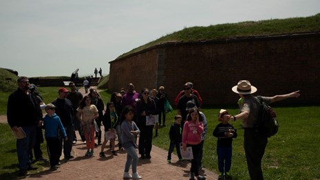 A park ranger at Fort McHenry giving a program in the fort's outer battery.