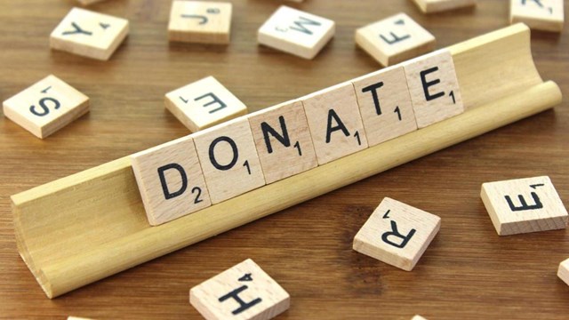 An image of donate spelled in Scrabble.