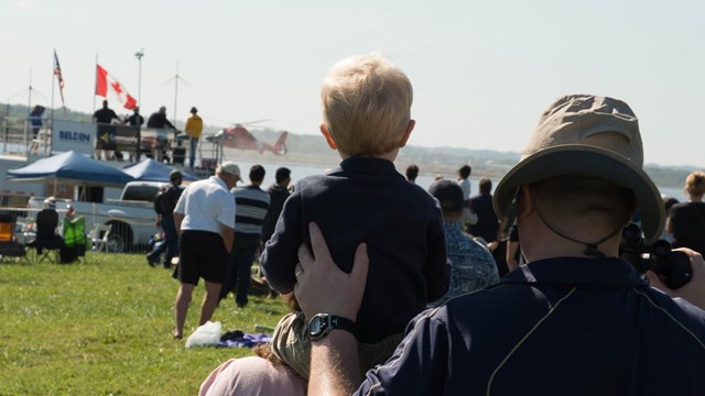Visitors watching a special park use permit in action.