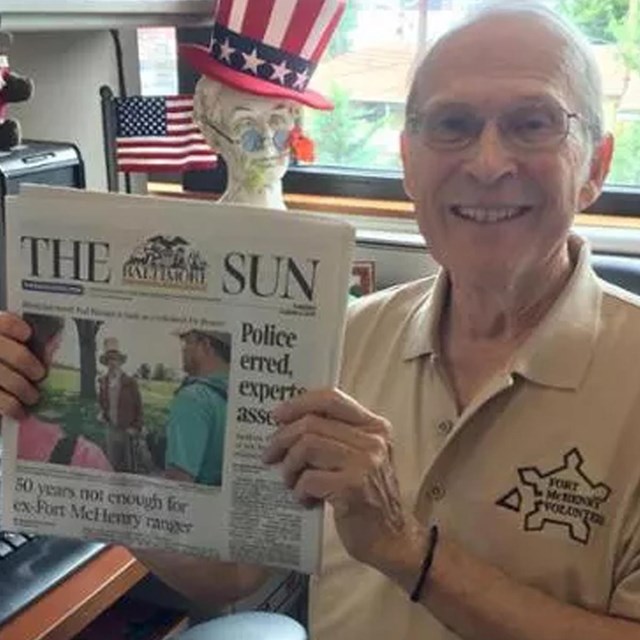 Man holding up newspaper
