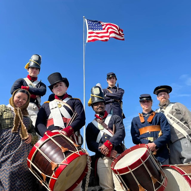 Living historians in Civil War uniforms with flag above