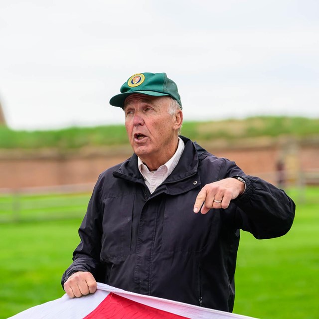 FOMC Volunteer assisting with flag demonstration