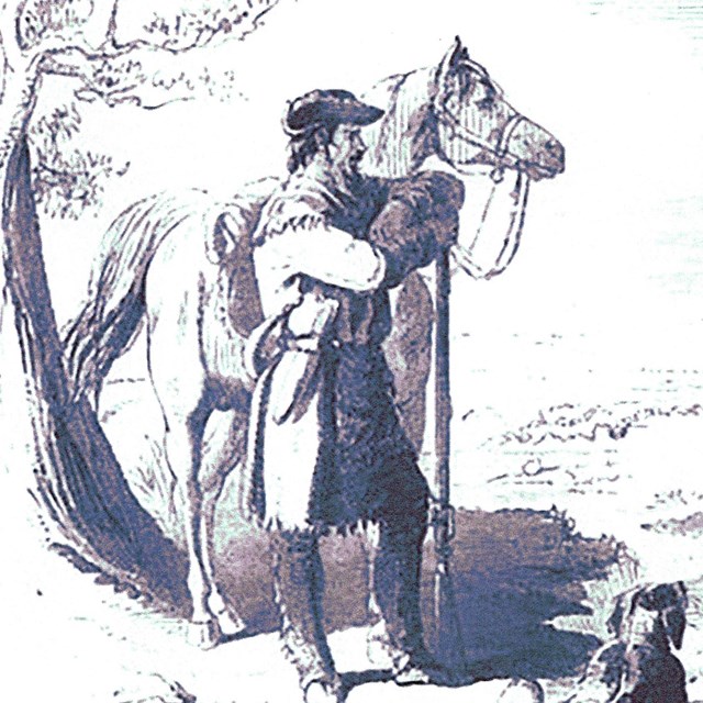 A man in frontier clothing standing by his horse